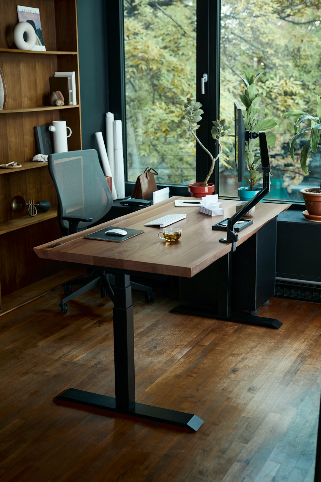 a-desk-with-a-laptop-on-it-in-front-of-a-window-tdnyk4qoghc